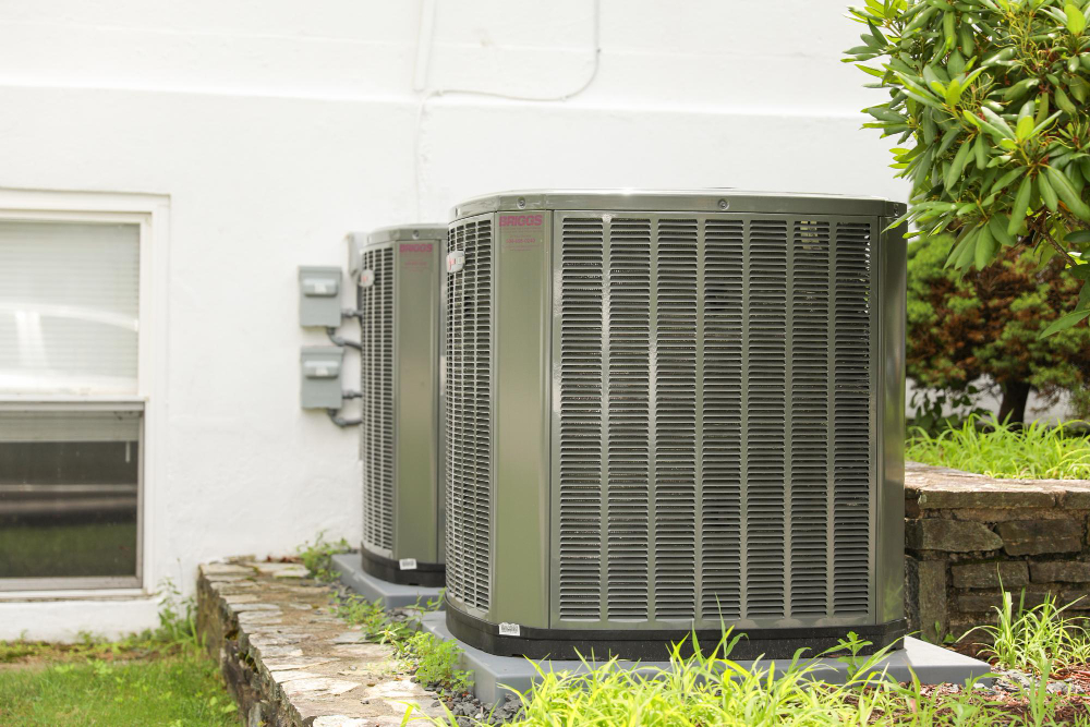 Zwei Außengeräte einer Wärmepumpe an der Hauswand, energieeffiziente Heizlösung für Einfamilienhäuser in der Region Bremen.